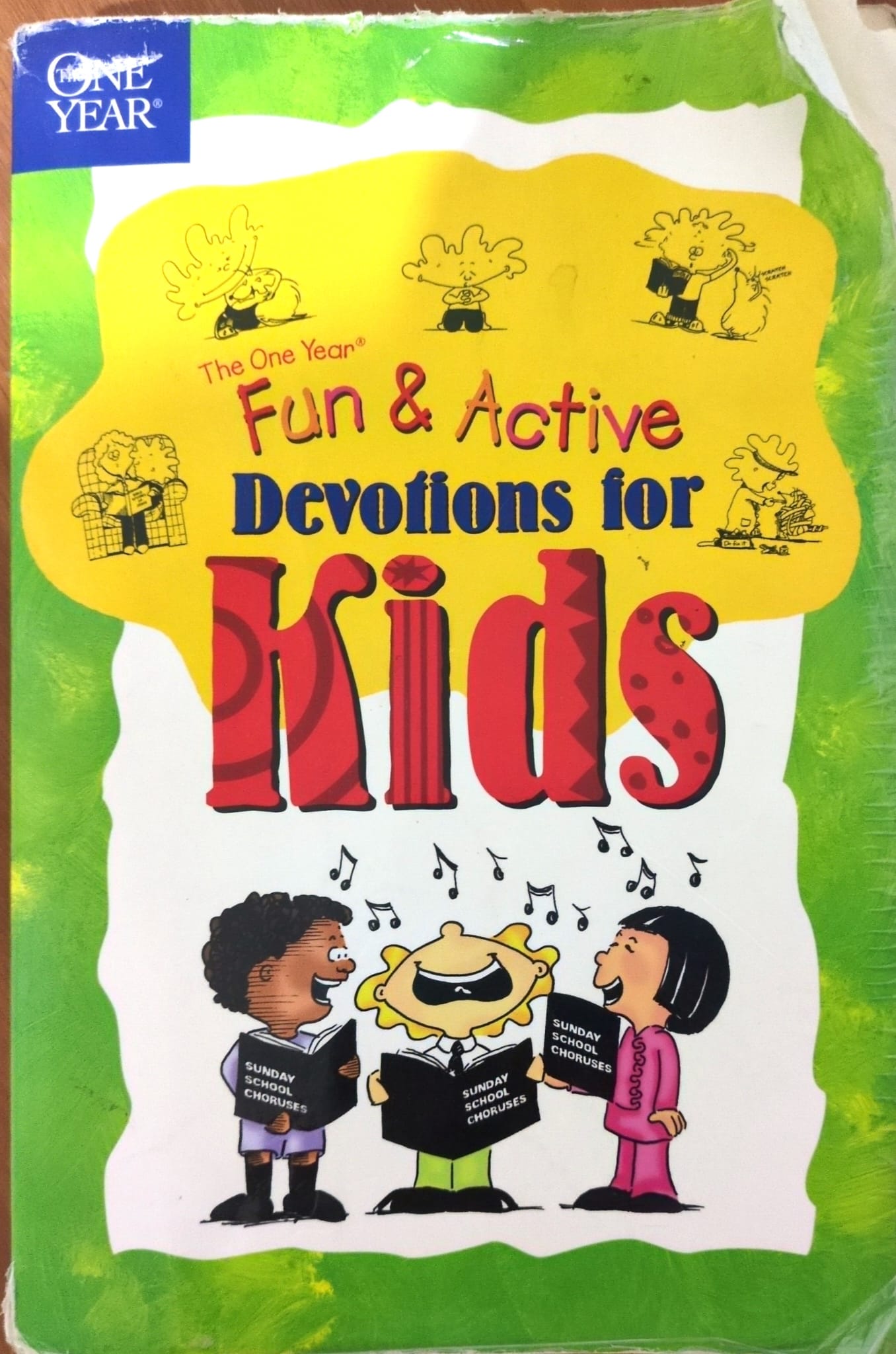 Book cover for "The One Year Fun & Active Devotions for Kids" of Inc. Carol Stream, Illinois Tyndale House Publishers